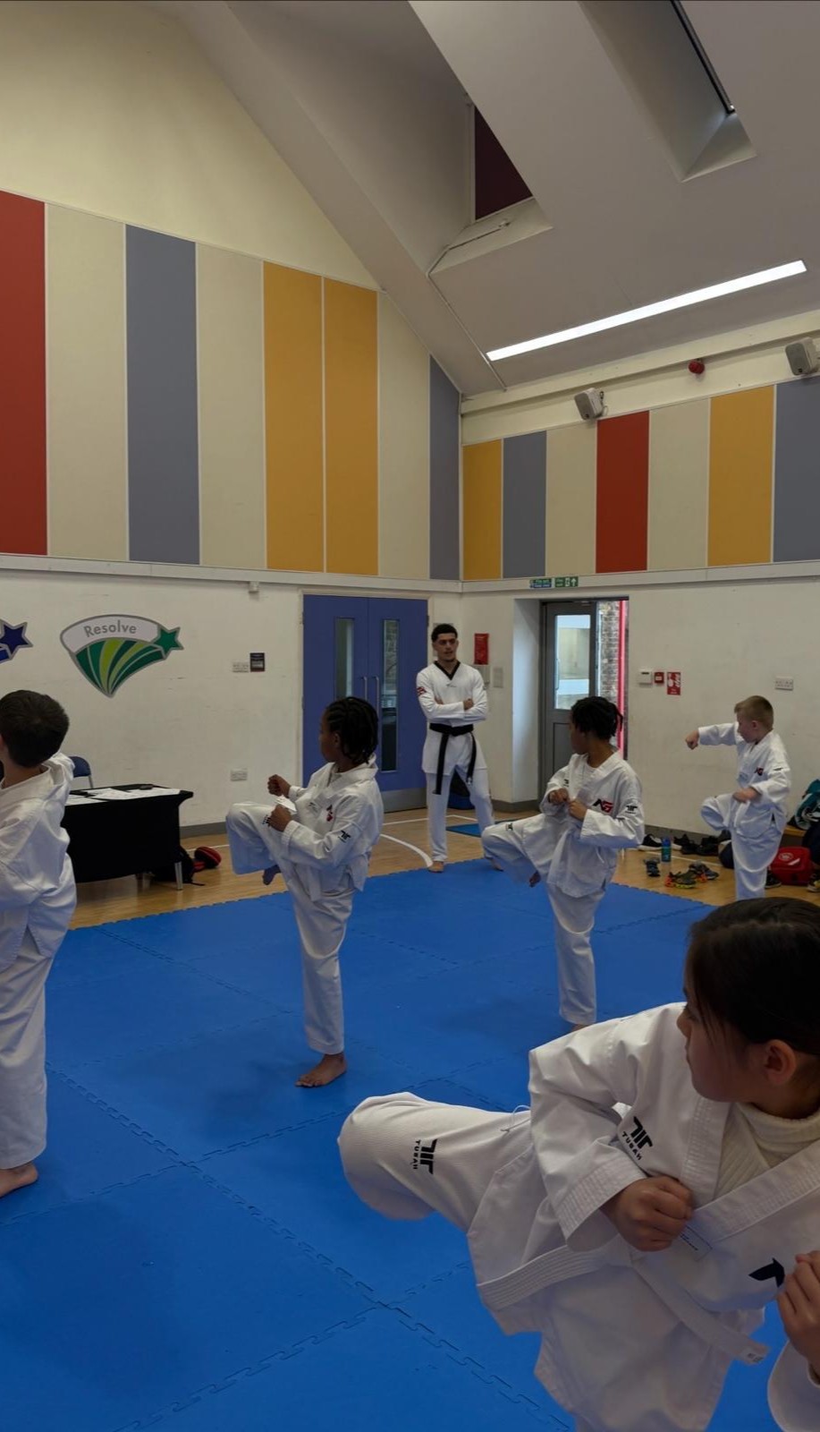 Children training with discipline in a Taekwondo class at NGTC Putney