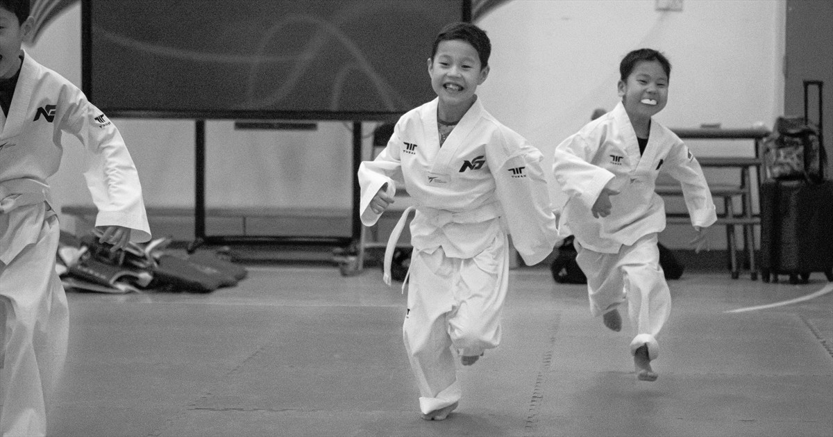 Children enjoying energetic martial arts and Taekwondo training in Putney