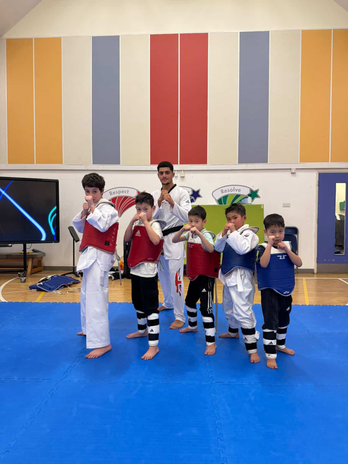 Instructor and students in ready stance at NGTC Taekwondo club, Putney